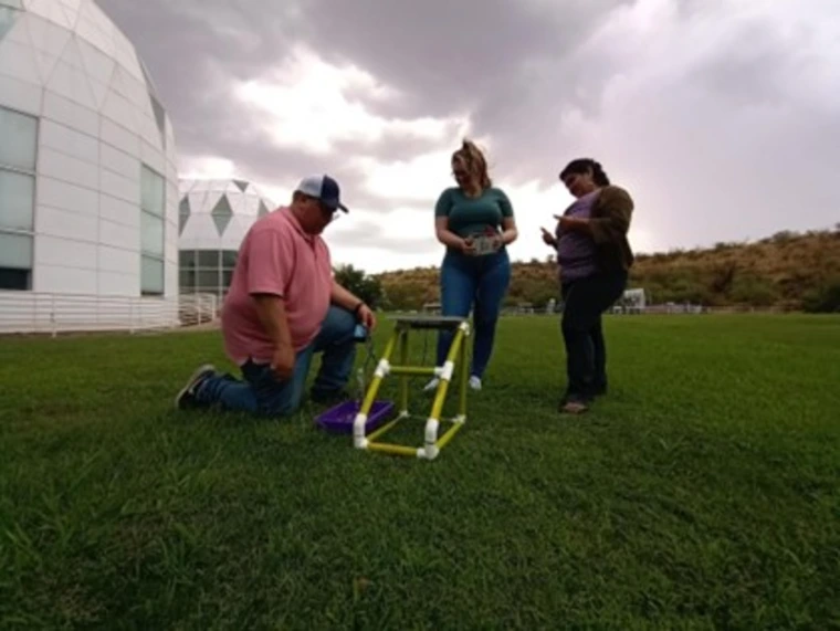 Participants collecting data outside the Biosphere 2 Lower Habitat Rooms with their new agrivoltaics kits